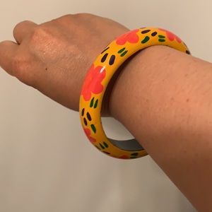 Wood bangle with pink flowers on orange background